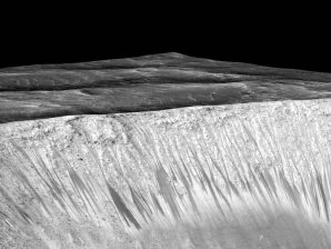 Dark narrow streaks emanating out of the walls of Garni crater on Mars. 