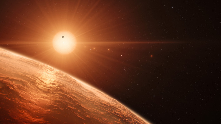 Imagem artística de uma estrela anã vermelha, com planetas a orbitar.